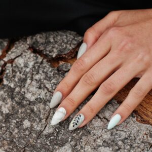 Woman nails in wooden background. Wedding manicure
