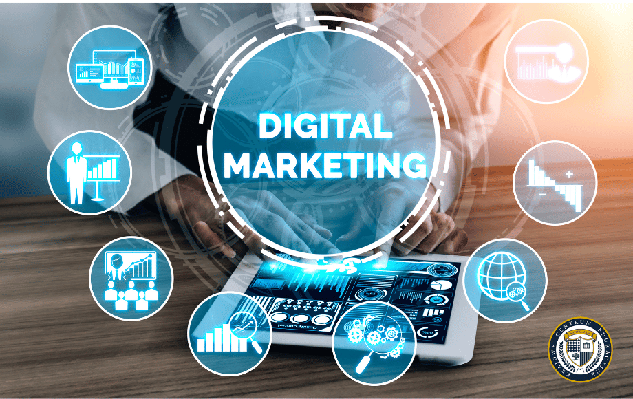 Koncepcyjna ilustracja digital marketingu przedstawiona jako interaktywna infografika. Centralnie umieszczony napis 'DIGITAL MARKETING' w niebieskim okręgu, otoczony okrągłymi ikonami reprezentującymi różne aspekty marketingu cyfrowego: wykresy analityczne, prezentacje biznesowe, statystyki, globalne zasięgi i narzędzia analityczne. W tle widoczny tablet z wyświetlonymi wykresami i danymi analitycznymi oraz dłonie osoby pracującej na urządzeniu. Grafika utrzymana w niebiesko-białej kolorystyce z pomarańczowym akcentem.
