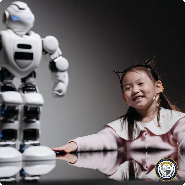 Uśmiechnięta dziewczynka w różowym swetrze interaktująca z białym robotem edukacyjnym, przedstawiająca zastosowanie sztucznej inteligencji w edukacji