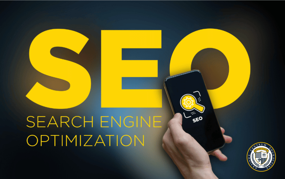 Smartphone wyświetlający ikonę SEO na tle dużego, żółtego napisu "SEO SEARCH ENGINE OPTIMIZATION"