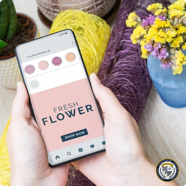 Ręce trzymające smartfon z aplikacją "Fresh Flower" do zamawiania kwiatów online