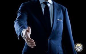 Osoba w eleganckim garniturze wyciąga rękę do uścisku dłoni podczas negocjacji biznesowych