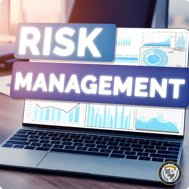 Laptop z wykresami analitycznymi na ekranie i holograficznymi napisami "Risk Management" unoszącymi się nad klawiaturą